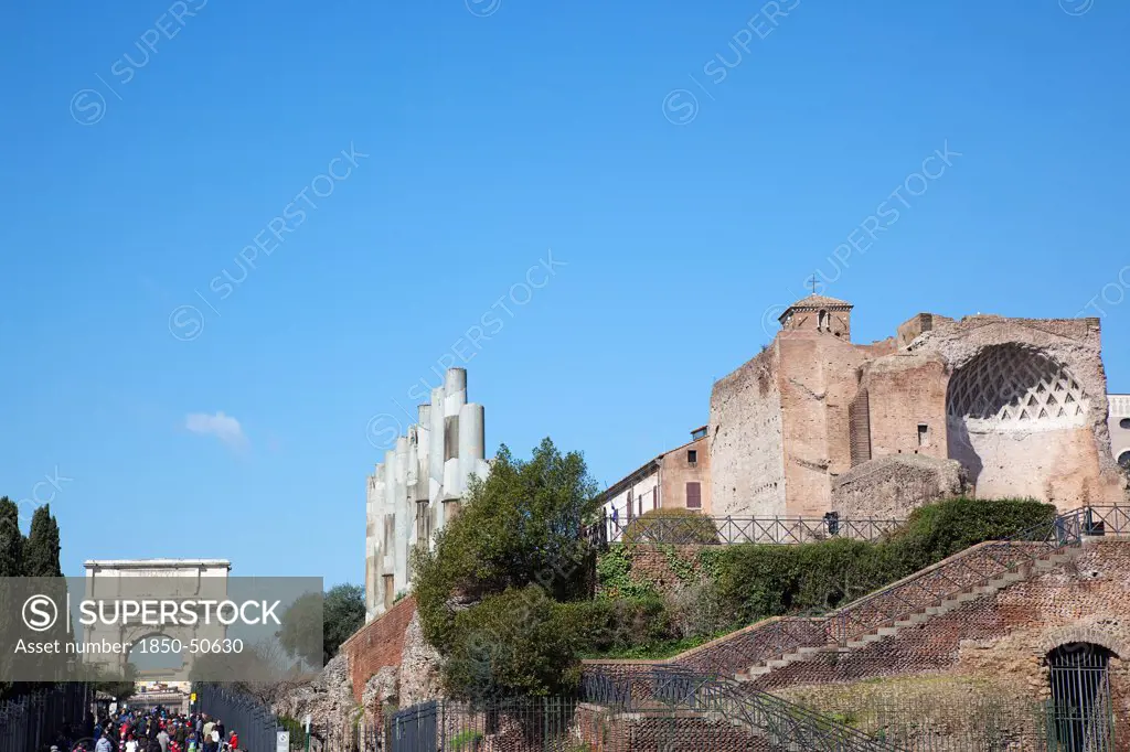 Italy, Lazio, Rome, Tourists walking up Via Sacra toward the Arch of Titus on Velian Hill.