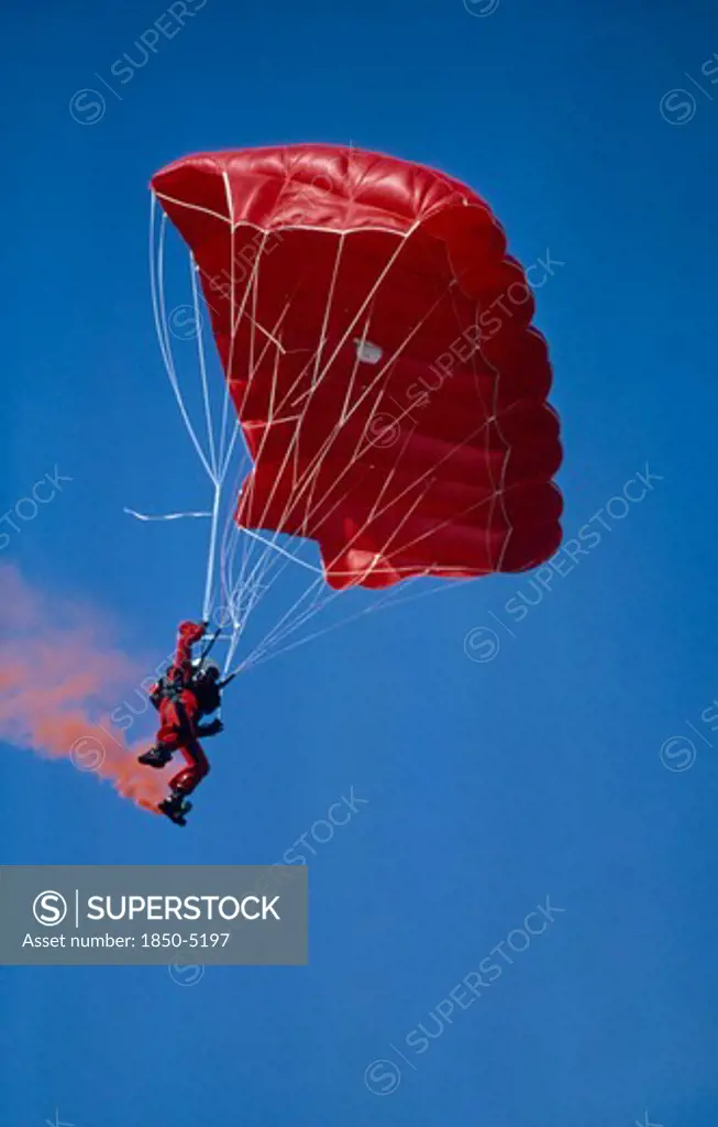 Sport, Air, Parachuting, 'Parachutist With Red Garments, Red Parachute And With Red Smoke Coming From His Boots.'