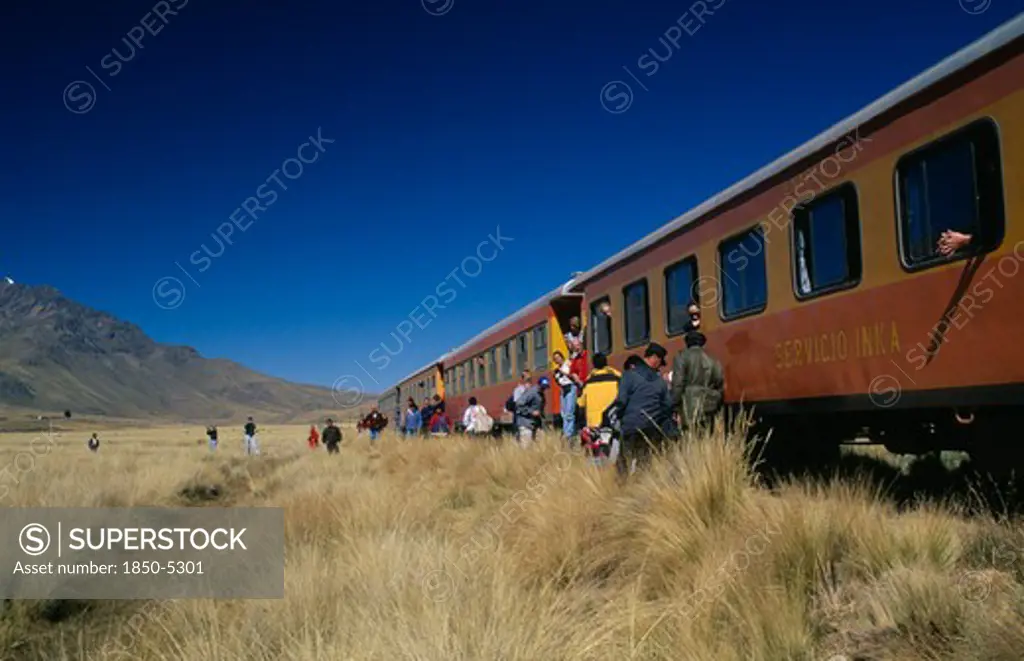 Peru, Puno Administrative Department, La Raya, Train Stopped On The Altiplano At The Highest Pass On The Line Between Puno To Cusco.  People Disembarking.
