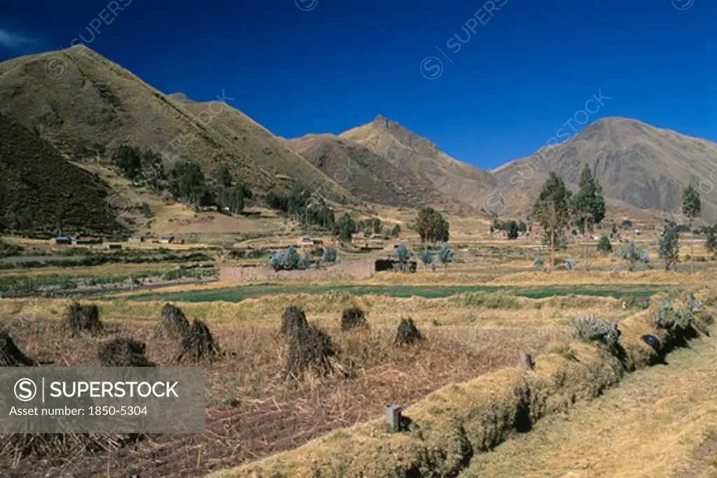 Peru, Puno Administrative Department, La Raya, 'View From The Train On The Altiplano.  Agricultural Land In The Foreground, Mountains Beyond.  '