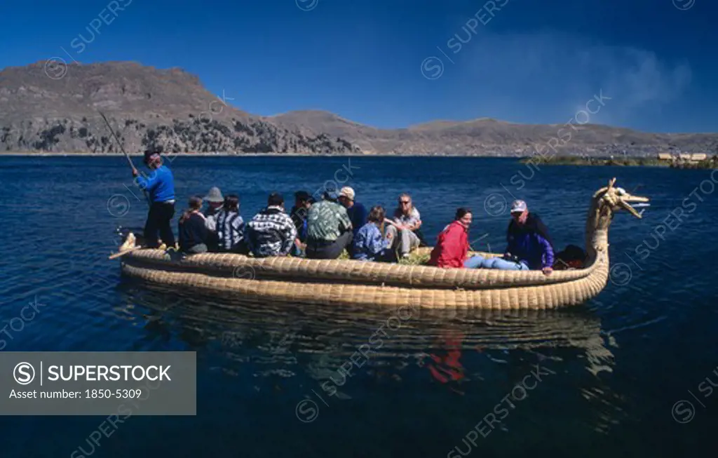 Peru, Puno Administrative Department, Puno, Lake Titicaca.  Tourists On A Reed Boat On The Lake.