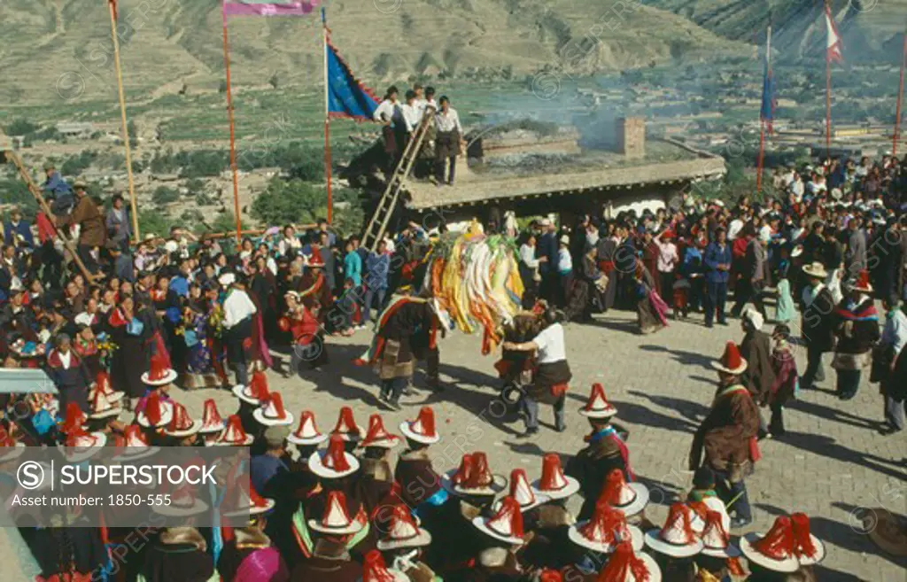 China, Quinghai, Tongren, Tibetan Festival With People Wearing Red Tassled Hats