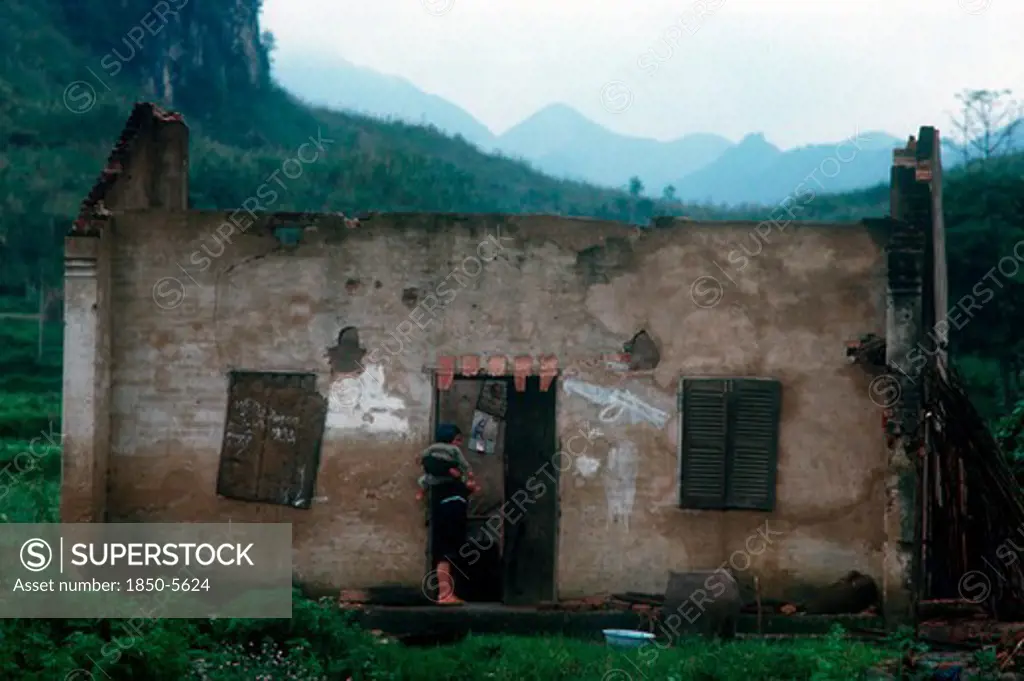 Vietnam, Lang Son Province, Dong Dang, 'Women Holding A Child, Standing In The Doorway Of The Ruined House In Which They Are Living.  China In The Distance.'