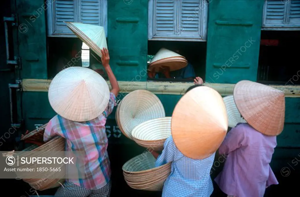 Vietnam, Hue, 'Traditional Conical, Straw Hats Being Sold To Train Passengers At Hue Station.'