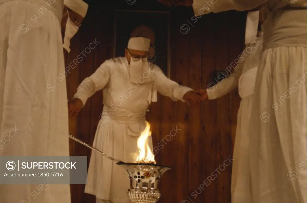 Society, Religion, Zoroastrian, Parsis Encircling Fire In A Temple.  Flames Burn Eternally In Their Fire Temples And Are Worshiped As A Symbol Of Their God Ahura Mazda.