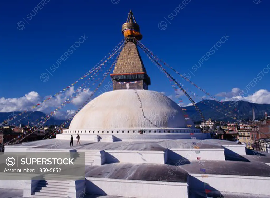 Nepal, Kathmandu, Bodhnath Stupa Hung With Prayer Flags With Visitors On Surrounding Steps.