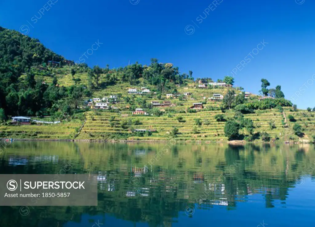 Nepal, Annapurna Region, Pokhara, View Over Lake Phewa With Reflected Terrace Hillside And Trees.