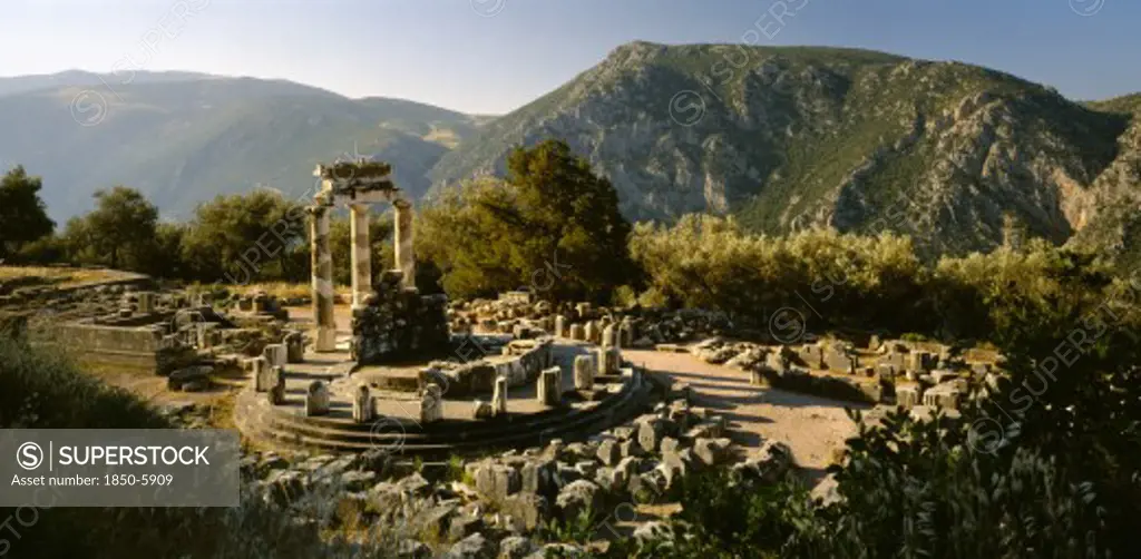 Greece, Central Greece, Delphi, Sanctuary Of Athena.  View Over Ruins In Mountain Landscape.