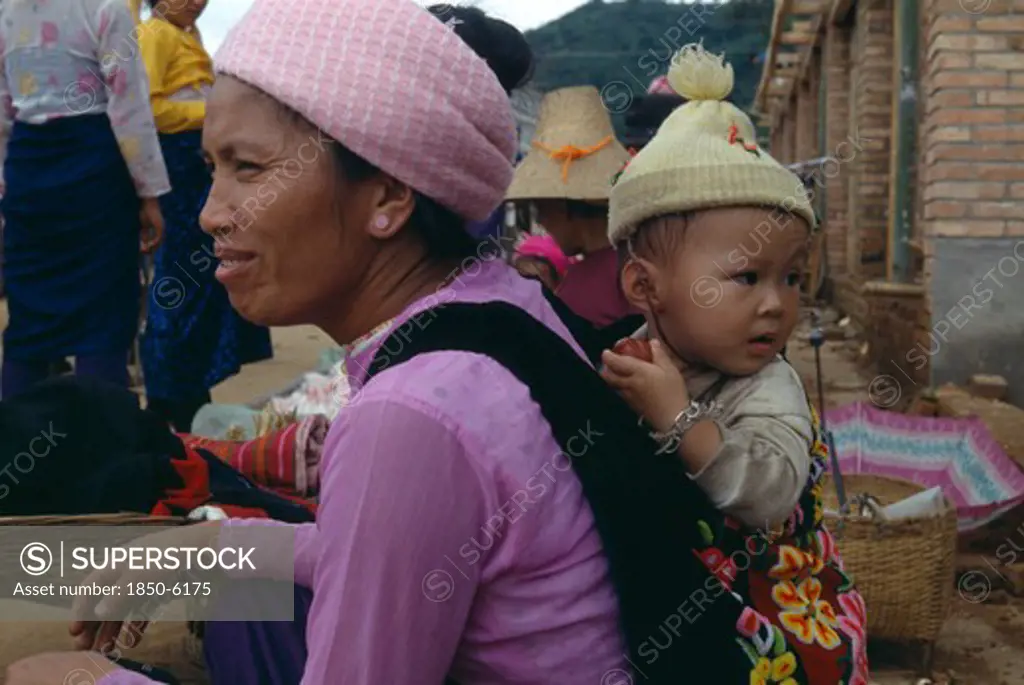China, Yunnan, Menghun, Dai Mother With Child On Her Back