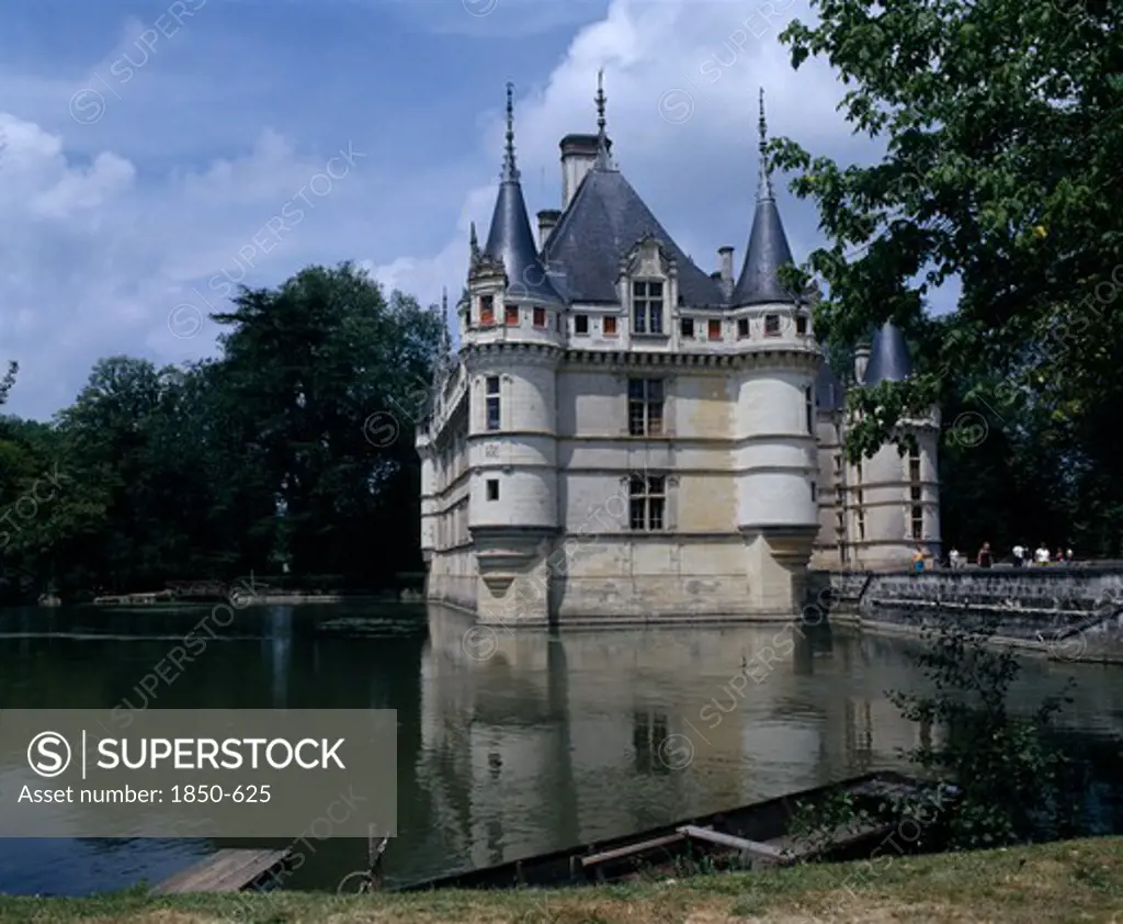 France, Loire Valley, Azay Le Rideau Chateau And Water Filled Moat Bridge Boat Moared On Bank In Foreground