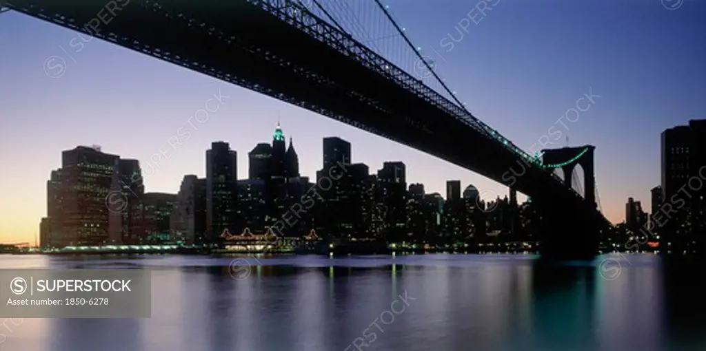 Usa, New York State, New York, Lower Manhattan.  Post September 11 Skyline From Brooklyn Illuminated At Night With Brooklyn Bridge In The Foreground.
