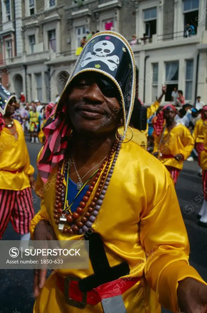 England, London, Notting Hill Carnival Man Dressed As A Pirate With Yellow Shirt And Skull And Crossbones Hat