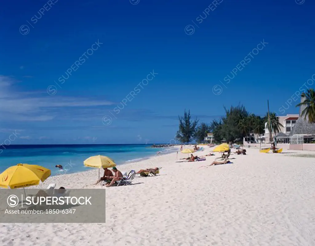 Barbados, South Coast, Dover Beach. , 'Golden Sandy Beach Lined With Palms, With Scattered Bathers, Sunbeds And Umberellas And Buildings Partially Hidden By Trees.'