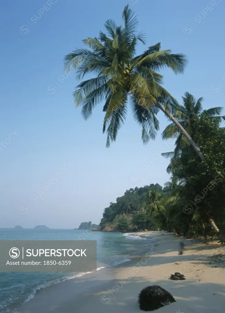 Thailand, Trat Province, Koh Chang, 'Lonley Beach, Aow Bai Lan. View Along The Sandy Bay With Overhanging Palm Tree And Small Islands In The Distance.'