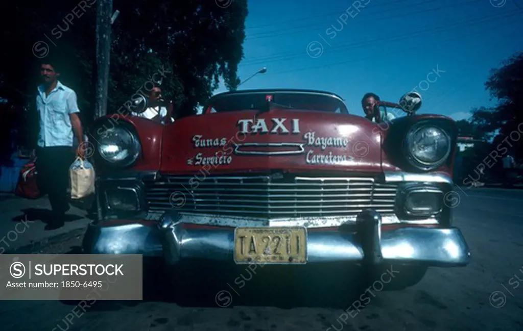 Cuba, Granma Province, Bayamo, Red 1950 S Cadillac Taxi Parked By The Kerb