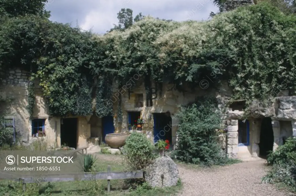 France, Loire, Les Maisons Trogladytes / La Fosse De Forges. Old Style Cottages Rooved By Overhanging Trees And Ivy.