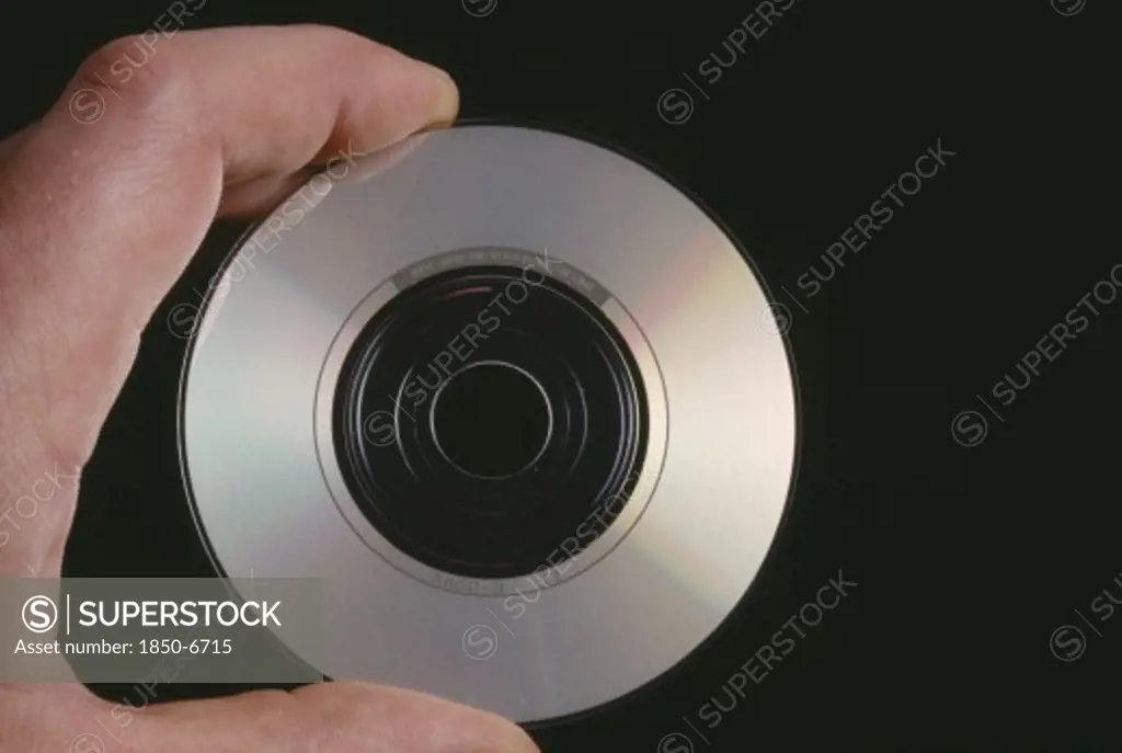 Music, Recorded, Compact Disc, Hand Holding A Cd Single Showing The Recorded Side