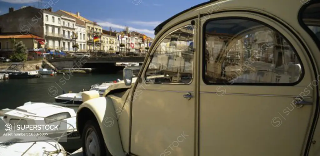 France, Languedoc-Roussillon, Herault, Sete.  Part View Of Harbour And Waterside Buildings With White Citroen Car In The Foreground.