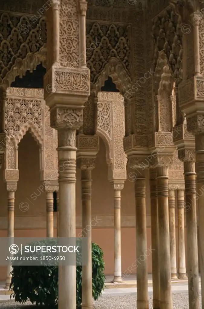 Spain, Andalucia, Granada, Alhambra Palace.  Detail Of Arches Lining The Patio De Los Leones.  Carved Stucco Dating From The Moorish Nasrid 13Th Century Period.