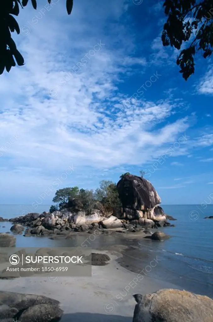 Malaysia, Penang, Batu Ferringhi, Batu Ferringhi Or Foreigners Rock Rising Out Of Shallow Water Beside Beach Of The Same Name.