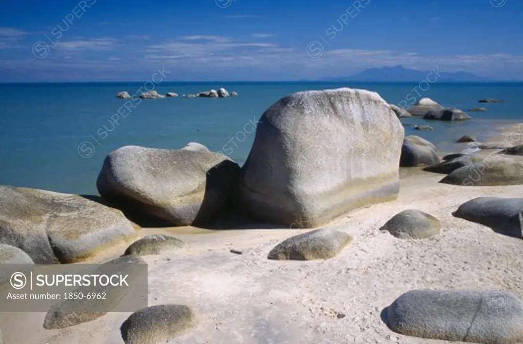 Malaysia, Penang, Batu Ferringhi, 'Beach And Large, Smooth Rocks With Sea Beyond.'