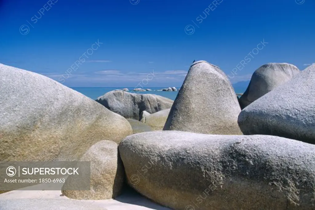 Malaysia, Penang, Batu Ferringhi, 'Beach With Close View Of Large, Smooth Rocks.'