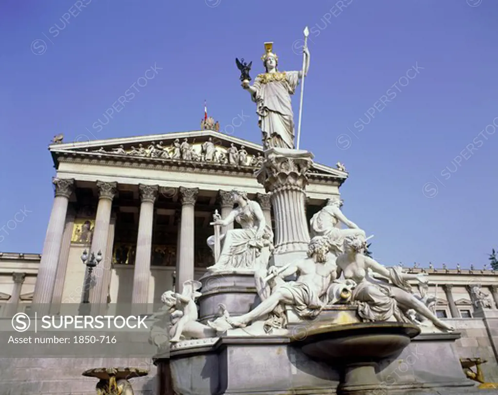 Austria, Lower, Vienna, Parliament House With An Ornate Stone Monument In The Foreground