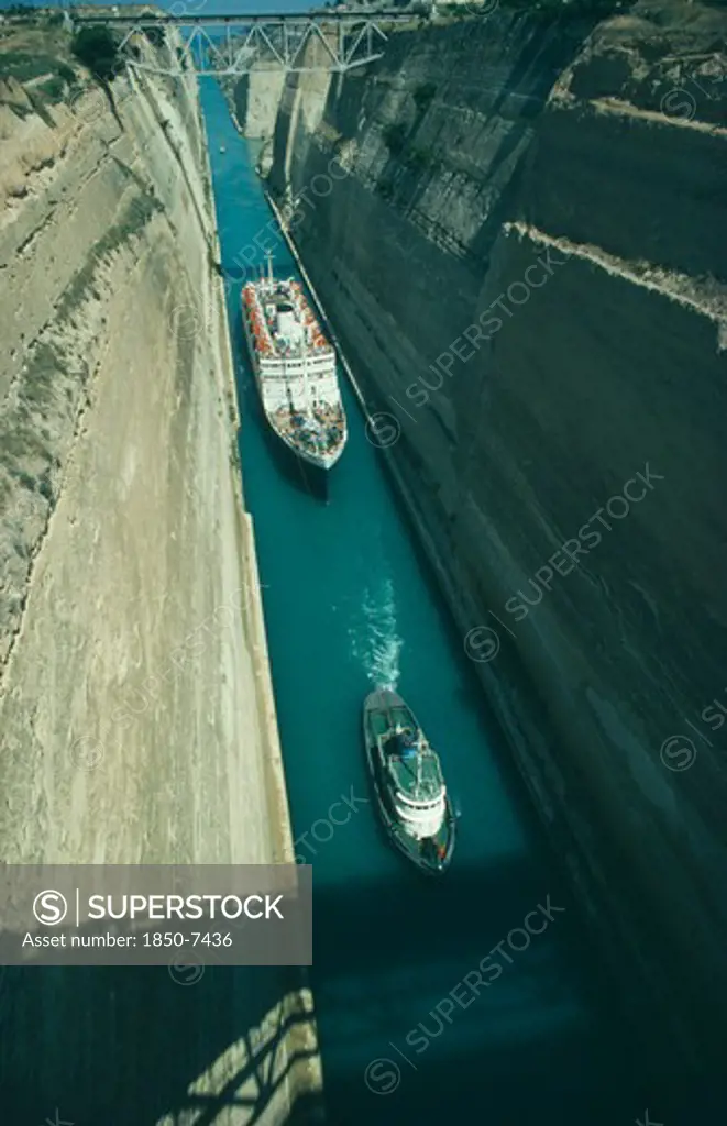 Greece, Peloponese, Corinth Canal, Cruise Ship Being Towed By A Tug Through The Canal