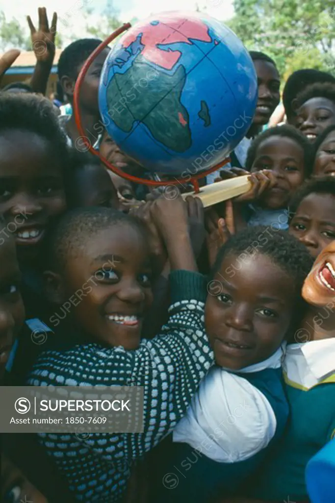 Malawi, Blantyre, School Children With Globe Made By Pamet Paper Making Project Which Produce Fair Trade Goods From Recycling Everything From Newspaper To Elephant Dung.