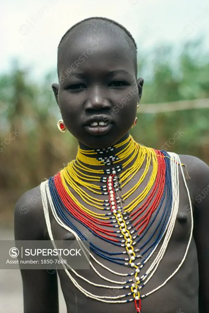 Sudan, Body Decoration, 'Young Dinka Girl Wearing Multi Stranded Necklace Made From Tiny Yellow, Red, Blue And White Coloured Beads'