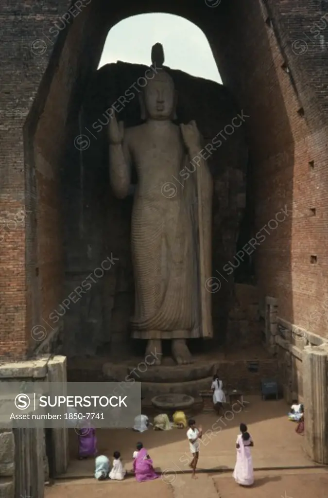 Sri Lanka, Aukuna, Large Standing Buddha Towering Over People Below