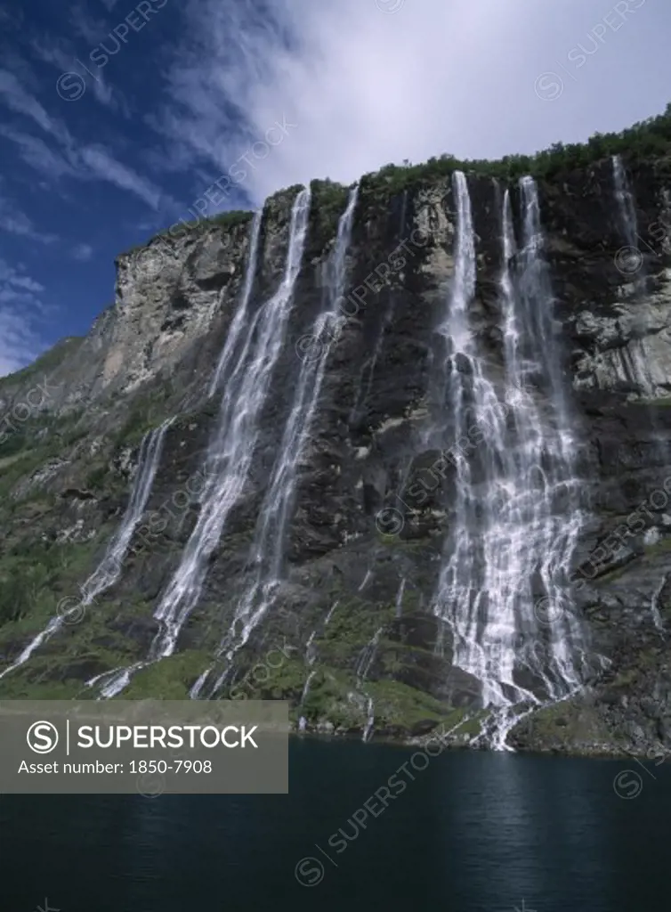 Norway, Romsdal, Geirangerfjord, Seven Sisters Mountain Cliff With Cascading Waterfall.