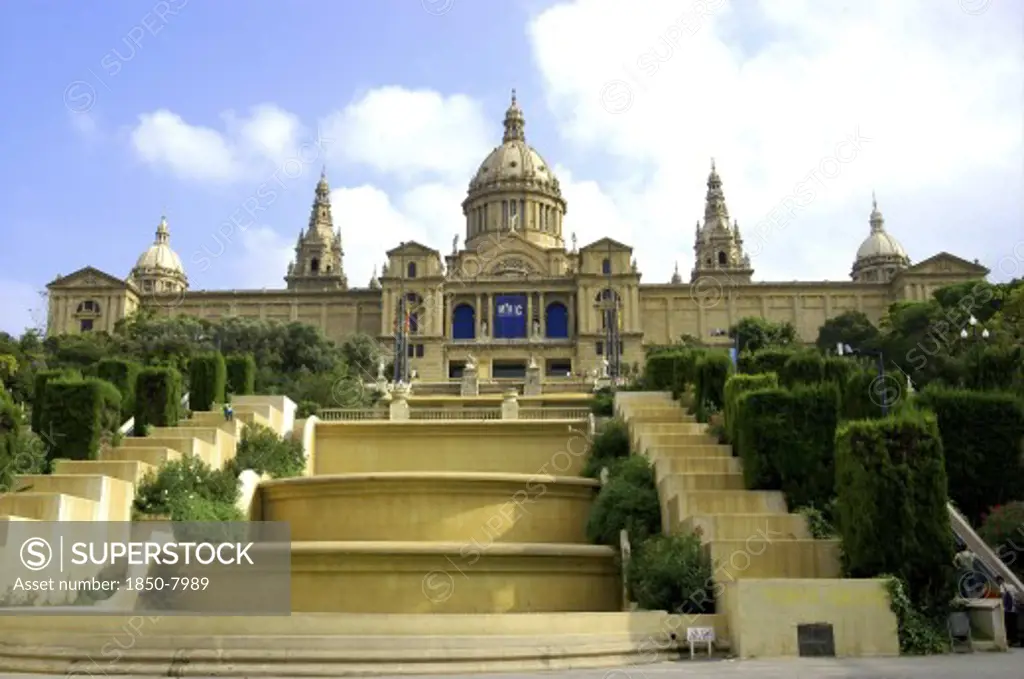 Spain, Catalonia, Barcelona, Royal Palace Museum Facade With Domed Roof And Steps Leading Down To The Foreground.