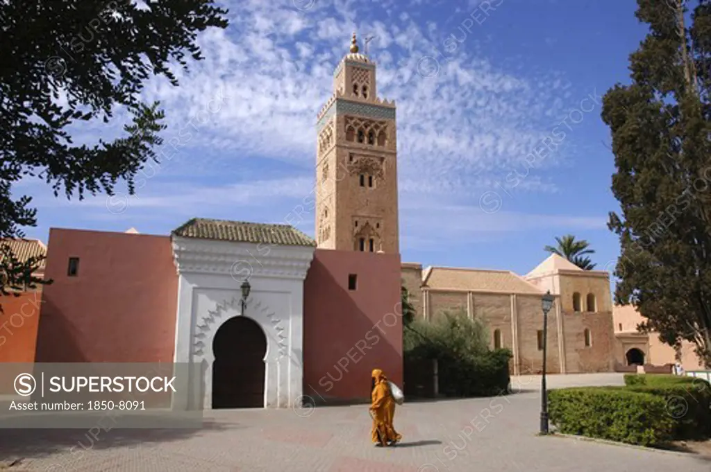 Morocco, Marrakech, Koutoubia Mosque With Entrance Gate And Tower And Passing Woman
