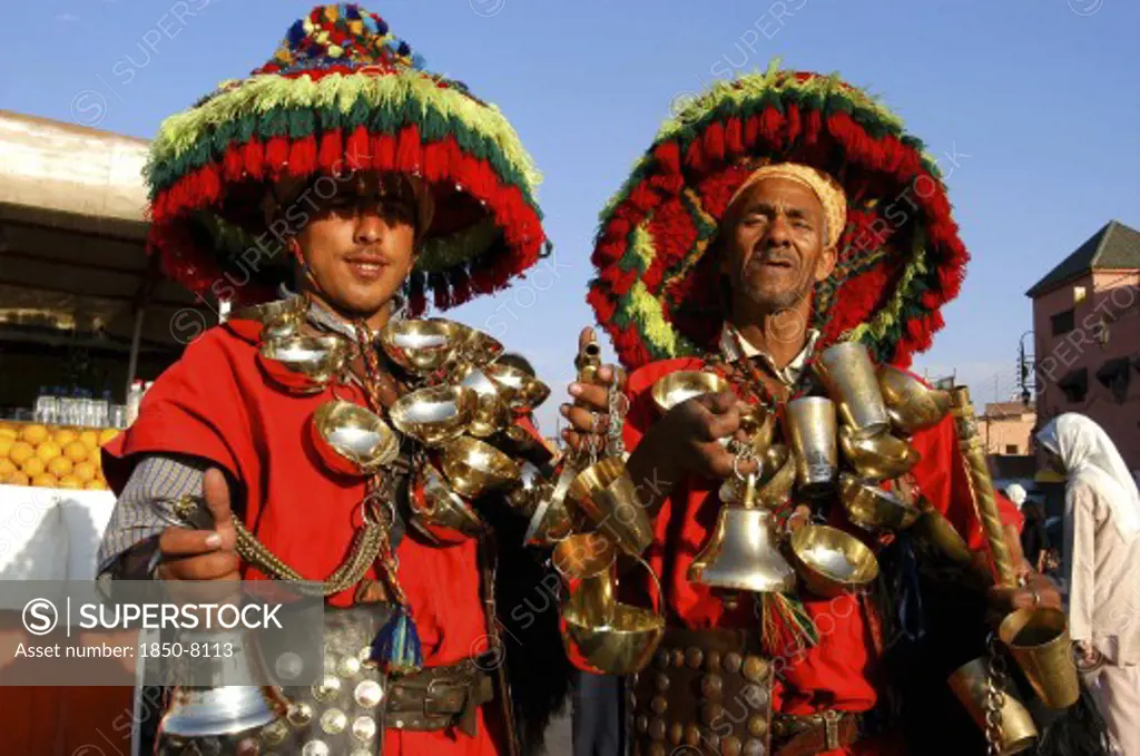 Morocco, Marrakech, Djemaa El Fna. Two Water Sellers Wearing Brightly Coloured Hats