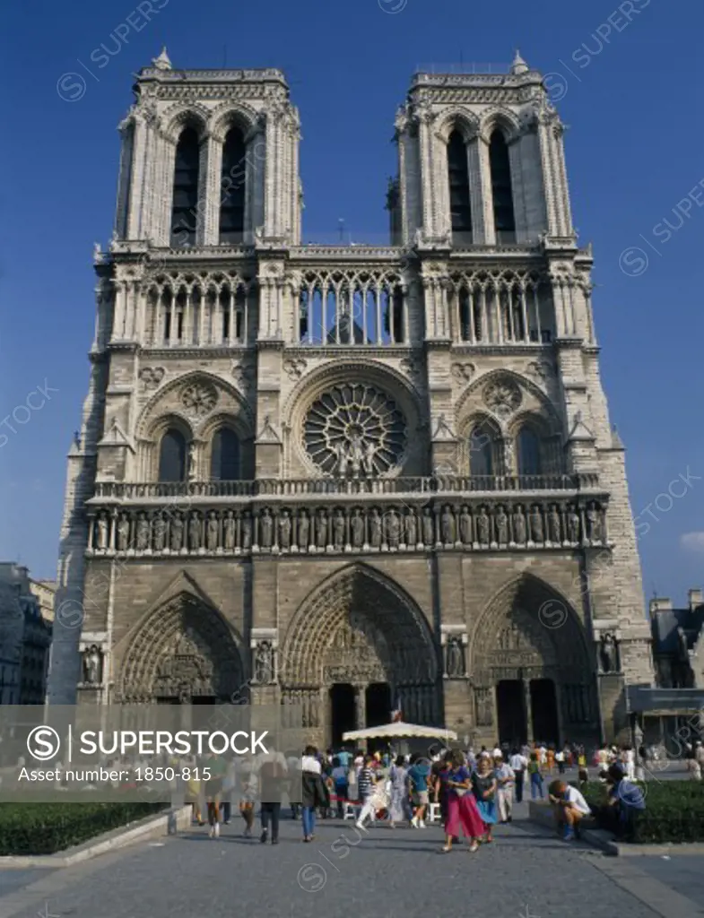 France, Ile De France , Paris, 'Cathdrale De Notre Dame.  Gothic Exterior With Twin Towers And Rose Window, Crowds Of Visitors Outside Entrance.'