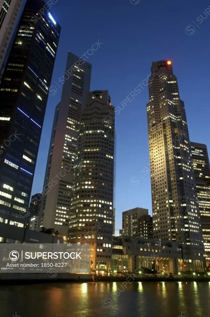Singapore, Raffles City, City Skyline Illuminated At Dusk