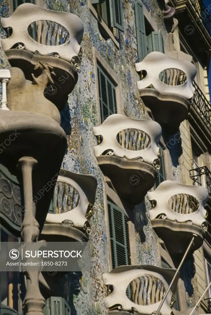 Spain, Catalonia, Barcelona, Illa De La Discordia Or Block Of Discord.  Casa Batllo Designed By Guadi 1904 To 1906.  Detail Of  Mosaic Covered Exterior Wall And Curved Balconies.