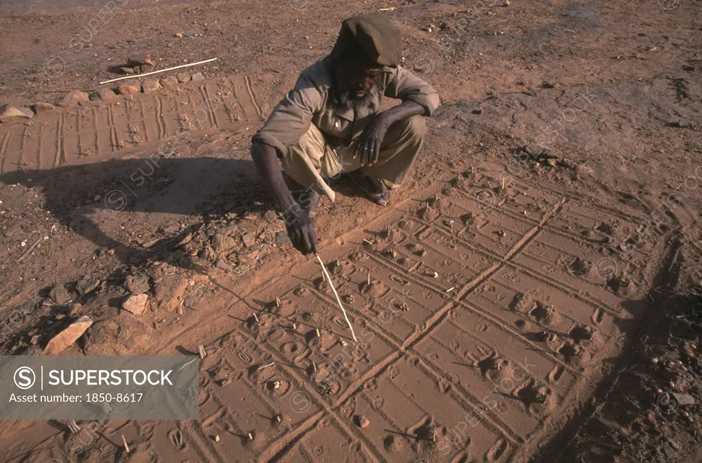 Mali, Pays Dogon, Bongo, A Dogon Sand Diviner Indicating Fox Paw Prints For Telling Fortunes.