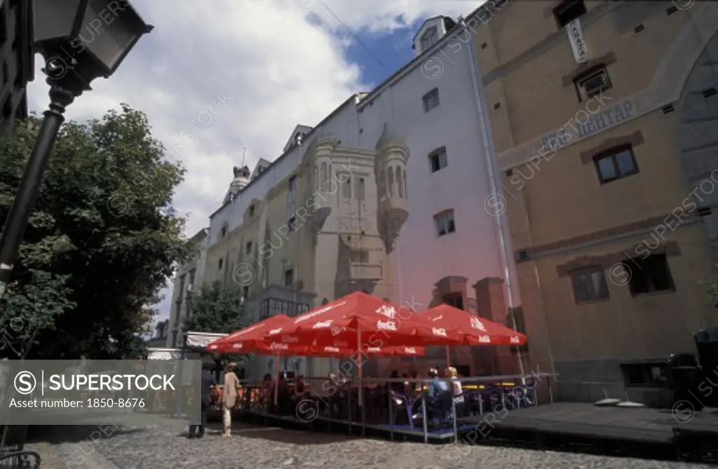 Serbia, Belgrade, View Of Restaurant With Red Table UmbrellaS In Skadarlija Pedestrian Area.