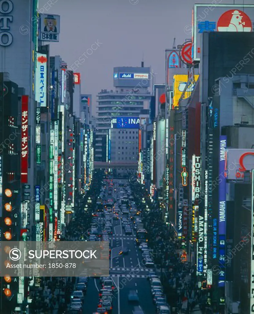 Japan, Honshu, Tokyo, View Down The Ginza At Night Busy With People And Traffic