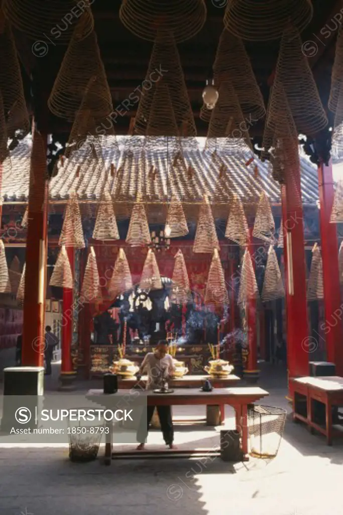 Vietnam, South, Saigon, Man At An Altar Below Coils Of Incense At Thien Hau Pagoda