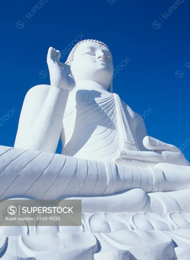 Sri Lanka, Mihintale, Angled View Of Large White Seated Buddha Seen From Below Looking Up.