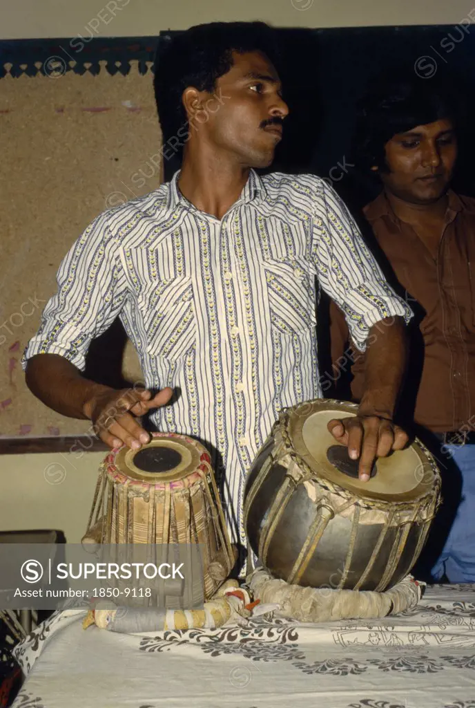 Bangladesh, Kamalganu, Young Man Playing Tabla Drums.