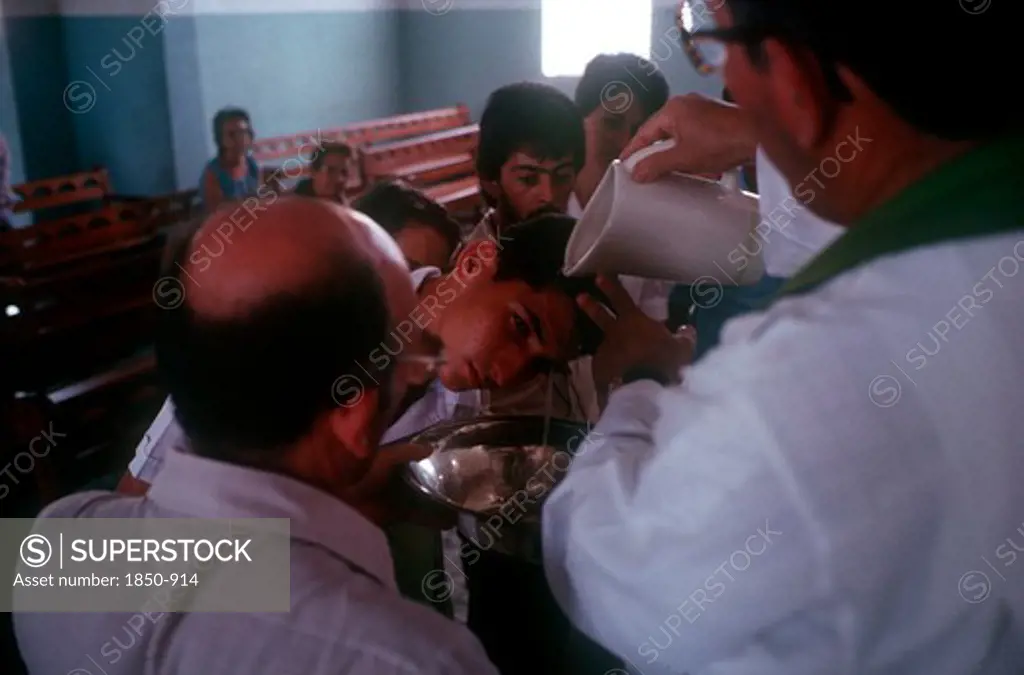 Cuba, Guimero , Man Having Holy Water Poured Over His Head By A Priest At An Adult Christening Service