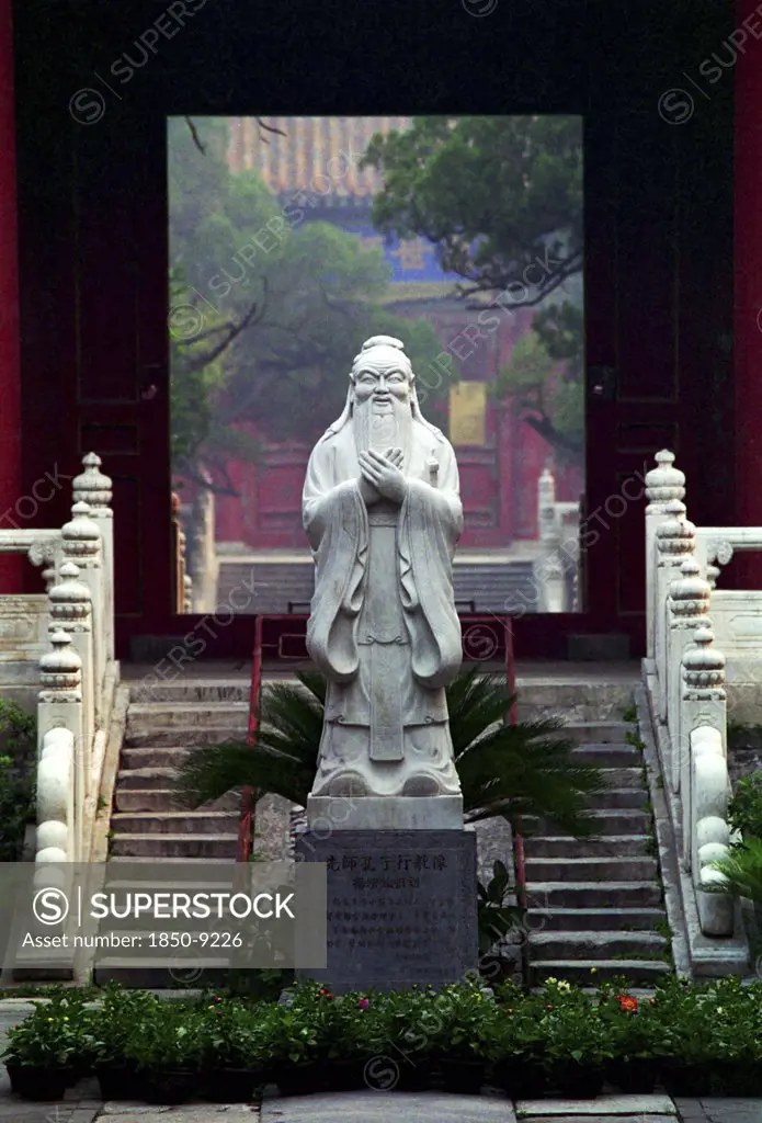 China, Beijing, Statue Of Confucius On Engraved Plinth At The Bottom Of Some Steps