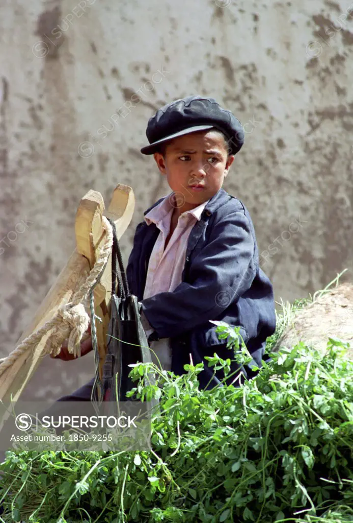 China, Xinjiang, Kashgar, Portrait Of A Young Boy Wearing A Cap