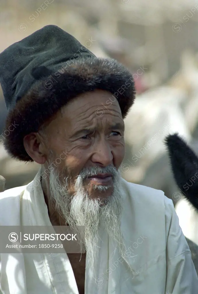 China, Xinjiang, Kashgar, Portrait Of An Elderly Man With A White Beard Wearing A Fur Rimmed Hat