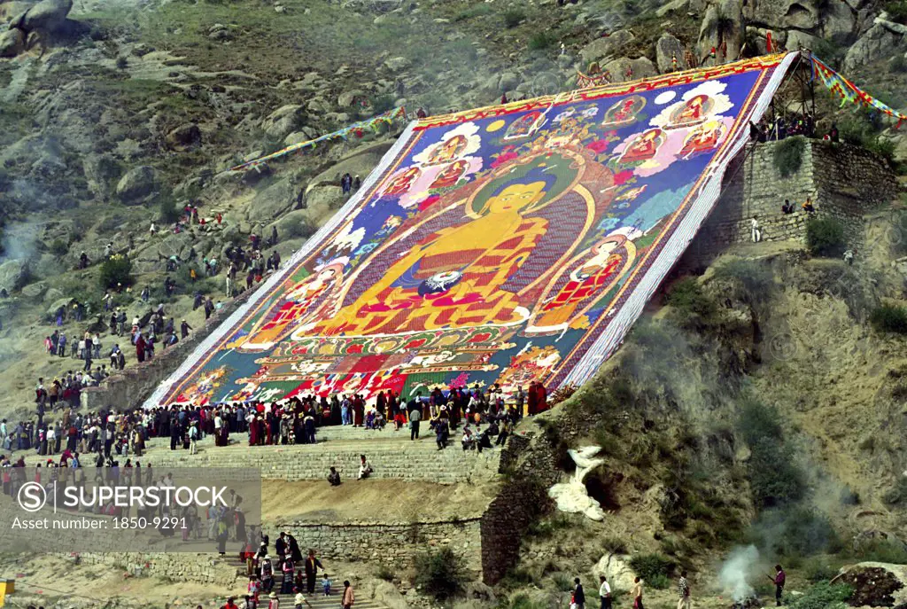 China, Tibet, Drepung Monastery, Parade Toward The Thangka And Onlookers At A Silken Thangka Buddhist Ceremony For The Cycle Of Life With Massive Brightly Colourd Hillside Buddha Image
