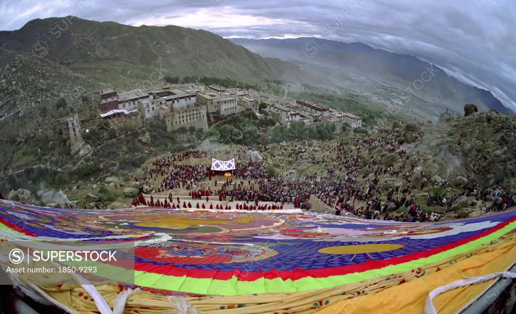China, Tibet, Drepung Monastery, Wide Angled View Looking Down Massive Colourful Image Of Buddha To Parade Toward The Thangka With Onlookers At A Silken Thangka Buddhist Ceremony For The Cycle Of Life